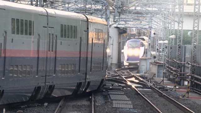 High-speed trains passing each other on outdoor tracks