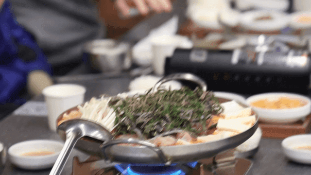Spicy beef hot pot simmering on restaurant table