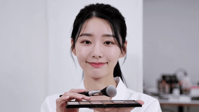 Woman applying makeup with brush