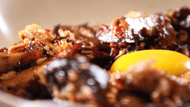 Mushroom dish topped with raw egg yolk