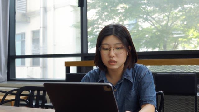 Woman wearing glasses having a meeting indoors