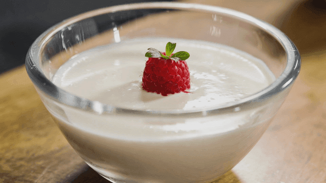 Cream yogurt dessert topped with raspberries