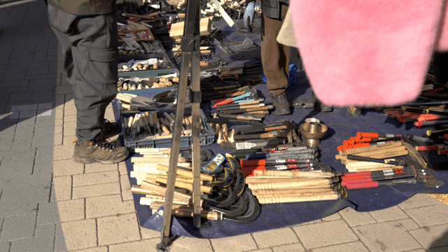 Outdoor market with various tools displayed