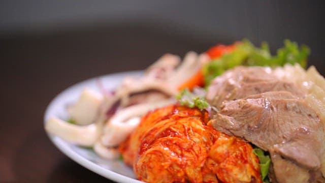 Steaming plate of bossam with kimchi