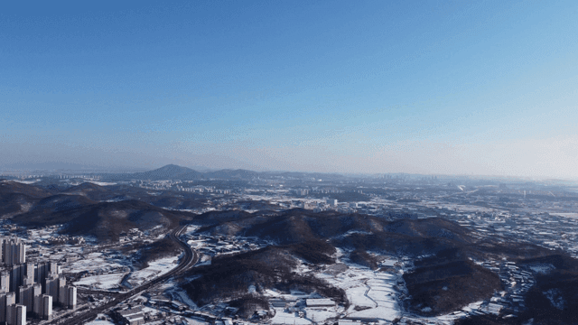 Aerial view of a city with snowy mountains