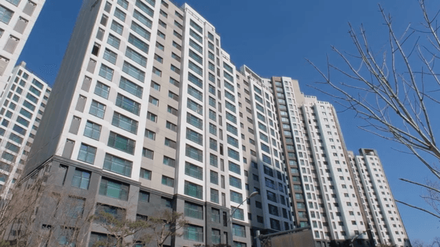 Tall apartment buildings under a clear sky