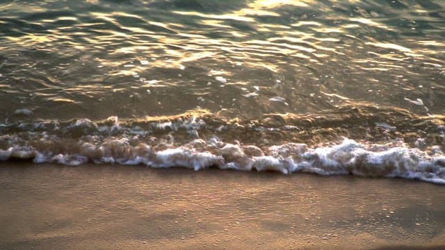 Waves gently lapping on a sandy shore