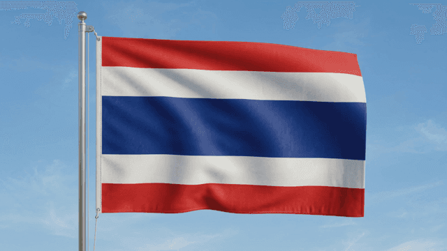 Thai flag fluttering against clear sky