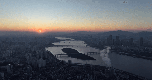 City skyline with river at sunset