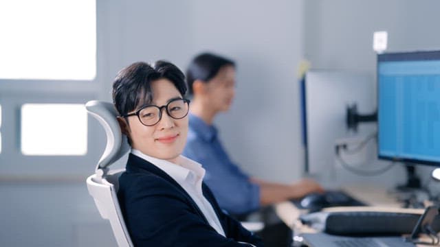 Man wearing glasses smiling in the office