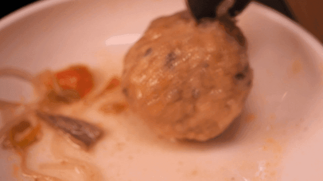 Rolled dumplings eaten by breaking them open with spoon on plate