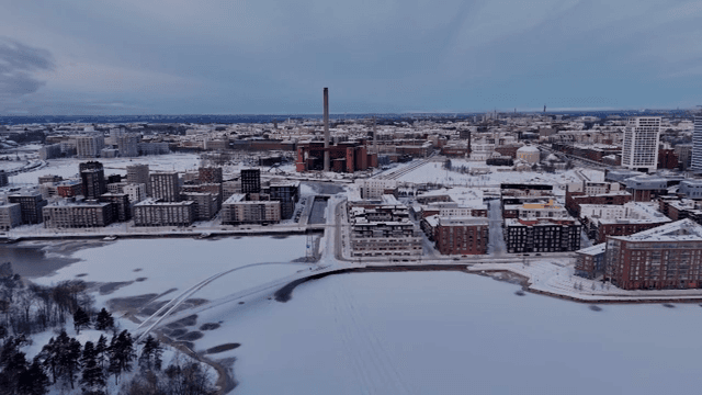 Snow-covered cityscape with frozen river