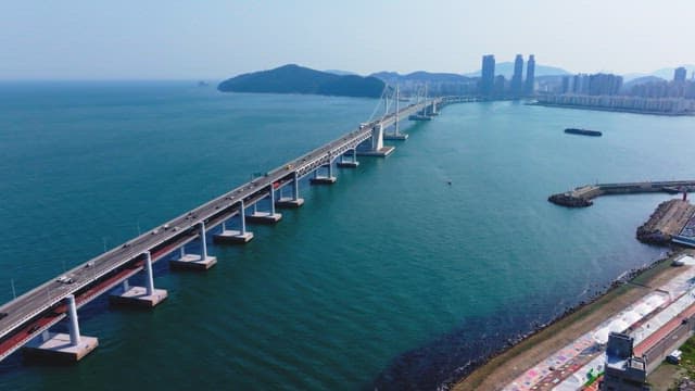 Gwangan Bridge scenery with many cars passing over the blue sea