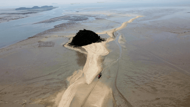 Small island surrounded by mudflats