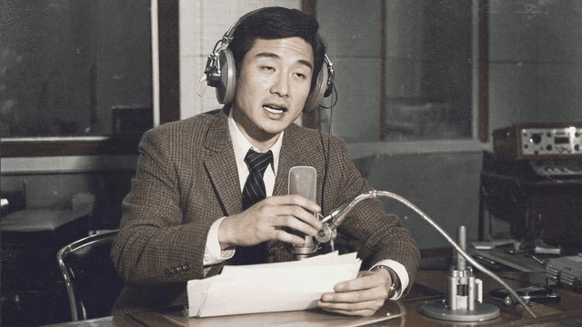 70s radio host wearing headphones