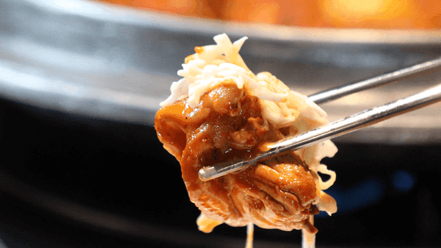 Spicy chicken jjaggi picked up with chopsticks