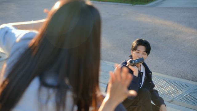 Couple filming a video with a camcorder in the park