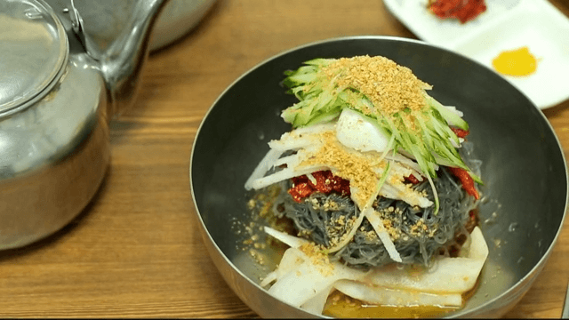 Delicious cold buckwheat noodles with raw pollack in a bowl