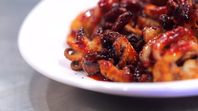 Spicy grilled webfoot octopus on a plate