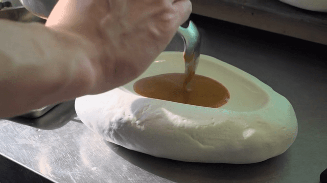 Sauce being poured into a unique bowl