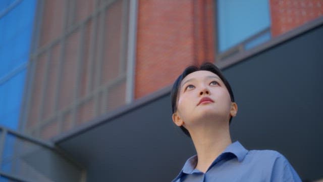 Woman standing in front of a red building