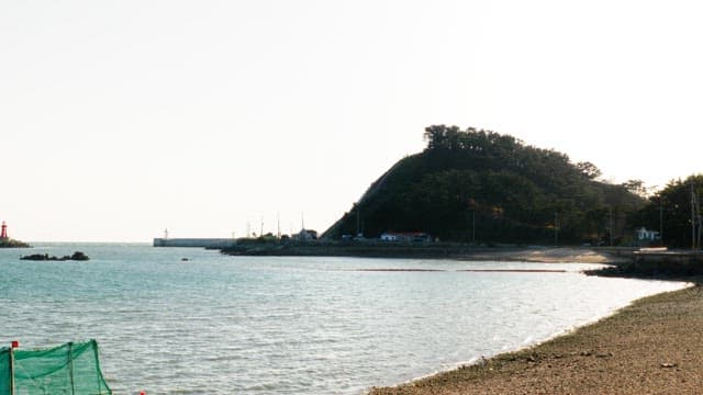 Coastal landscape with light houses and distant hills