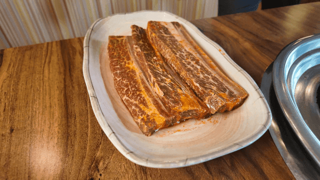 Soy sauce beef short ribs served at table