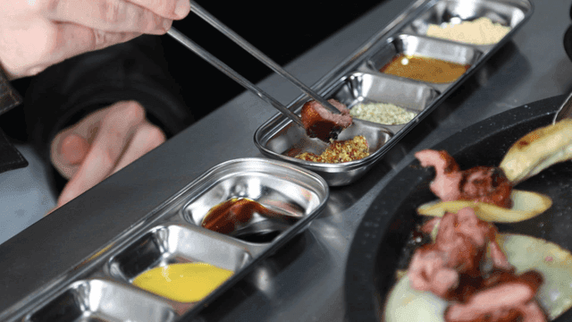 Various sauces on table and chopsticks for dipping grilled meat