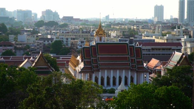 Traditional Thai temple amidst a bustling cityscape