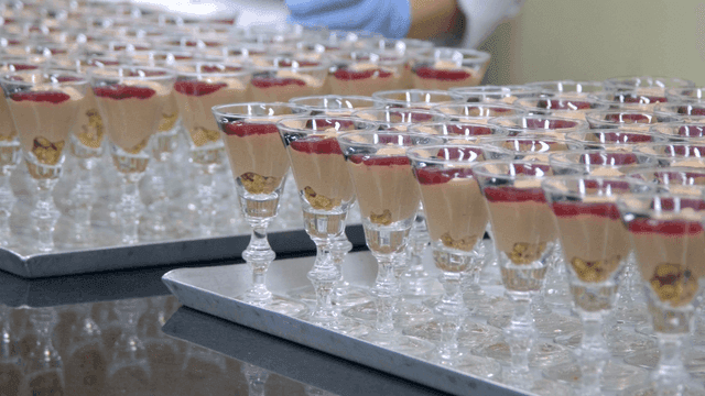 Rows of elegant dessert glasses on trays