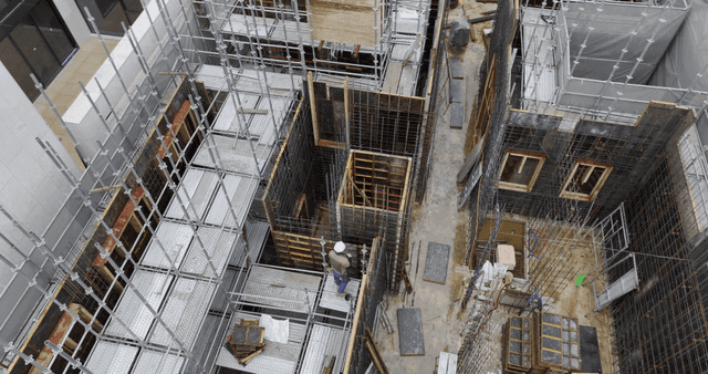 Construction site with scaffolding and worker