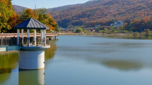 Peaceful Baegunhosu Lake surrounded by walking trails and autumn mountains