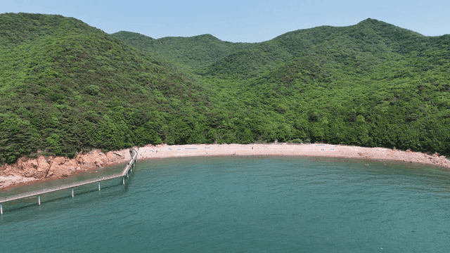 Quiet beach with green hills