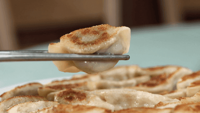 Crispy fried dumpling place uses chopsticks