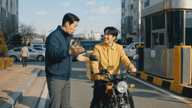 Security guard talking to motorcycle delivery driver