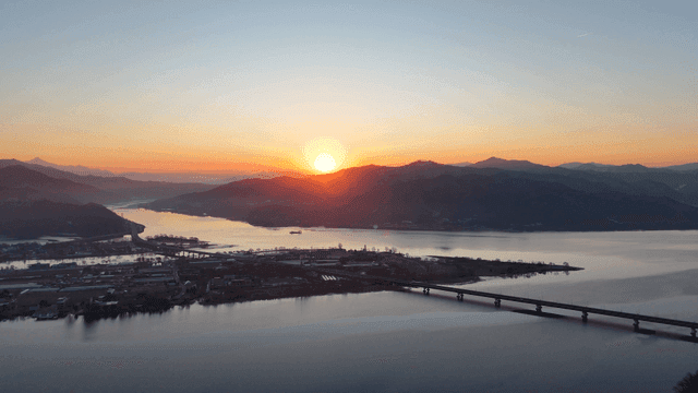Sunset over a serene river and mountains