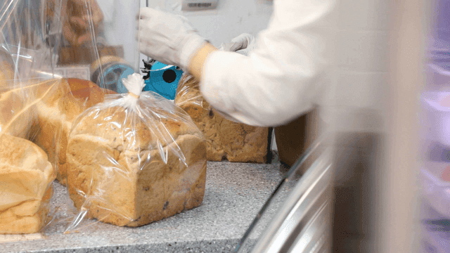 Person packaging freshly baked bread