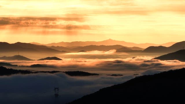 Sunrise over misty mountains