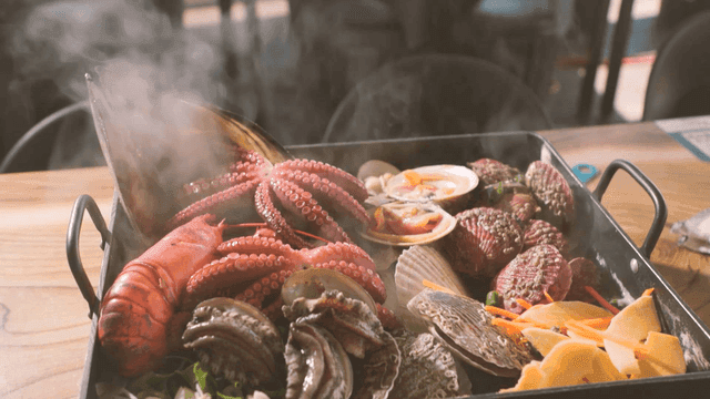 Steaming seafood platter with octopus and clams