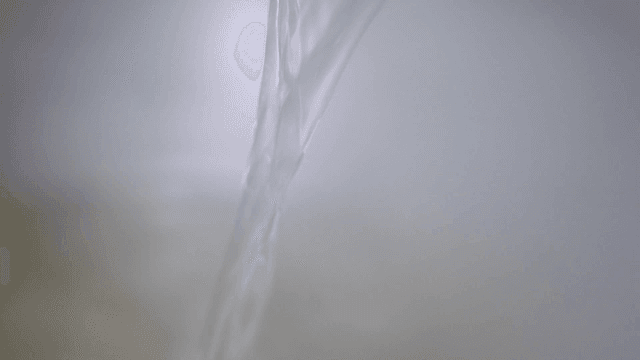 Hot broth poured from ladle into pot