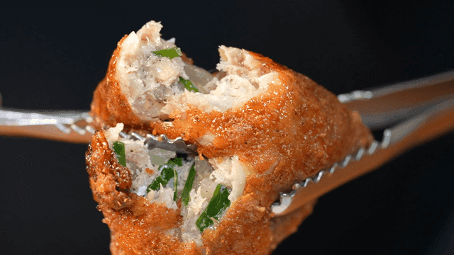 Fried chicken skin dumplings torn with tongs