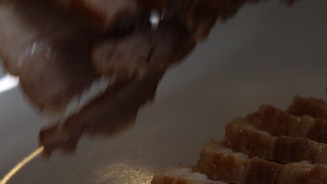 먹음직스럽게 조리된 수육을 플레이팅하는 모습