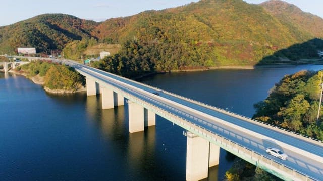 Bridge over a Lake Surrounded by Mountains