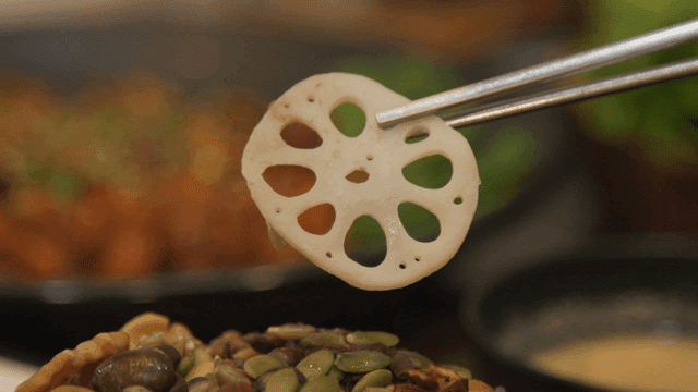 Chopsticks picking up lotus root on lotus leaf rice
