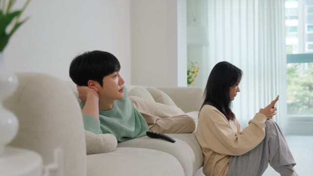 Two People Relaxing in a Bright Living Room