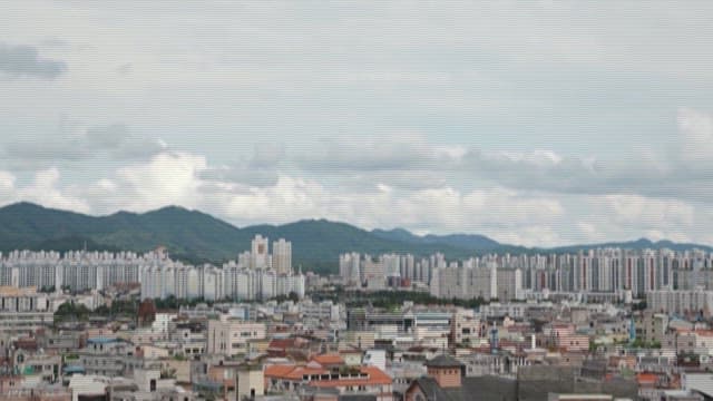 Cityscape with Buildings and Distant Mountains