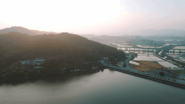 Serene sunrise scene with mountains and fields