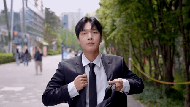 Male office worker walking down the street after tidying up his suit