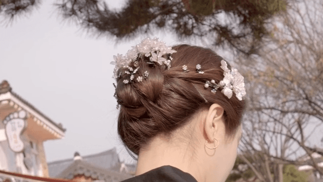 A woman wearing traditional Korean hanbok and a headdress