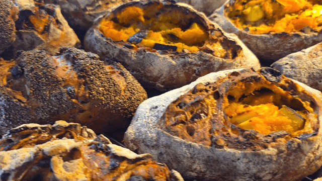 Various freshly baked breads displayed in bakery